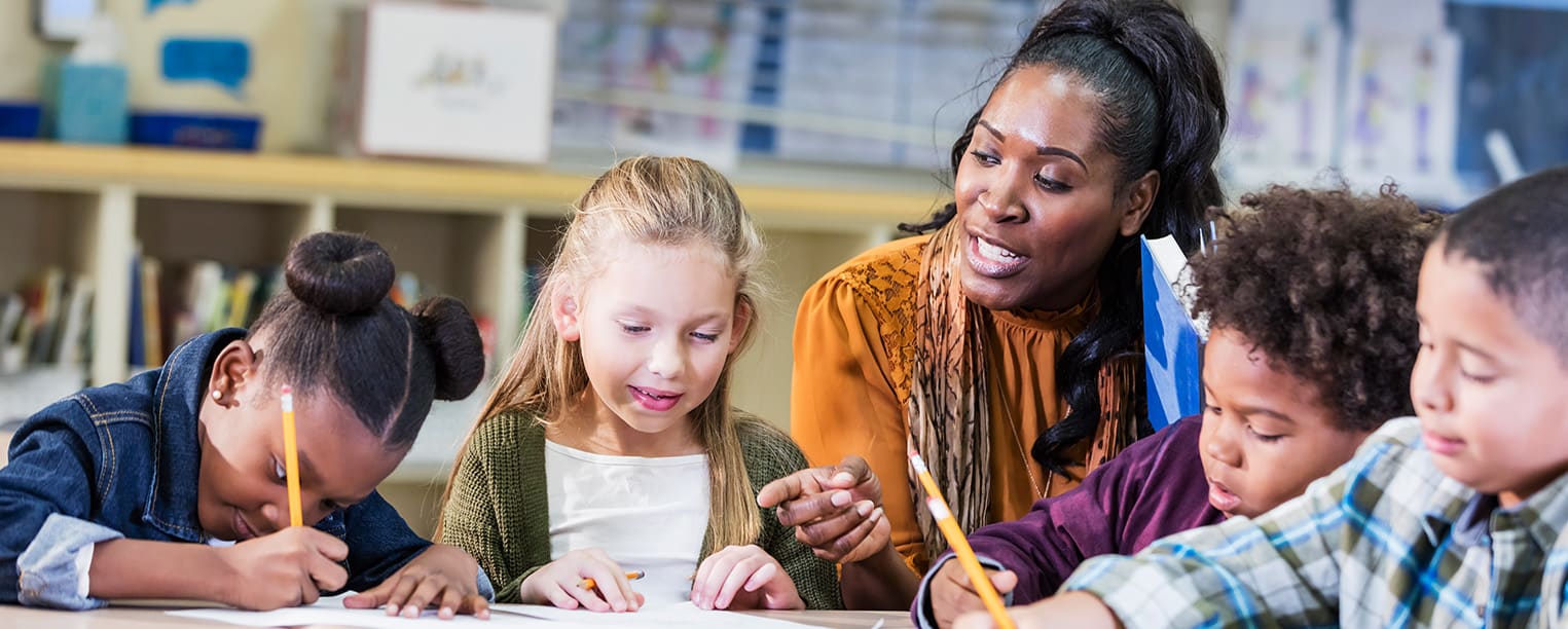 Image of teacher helping students