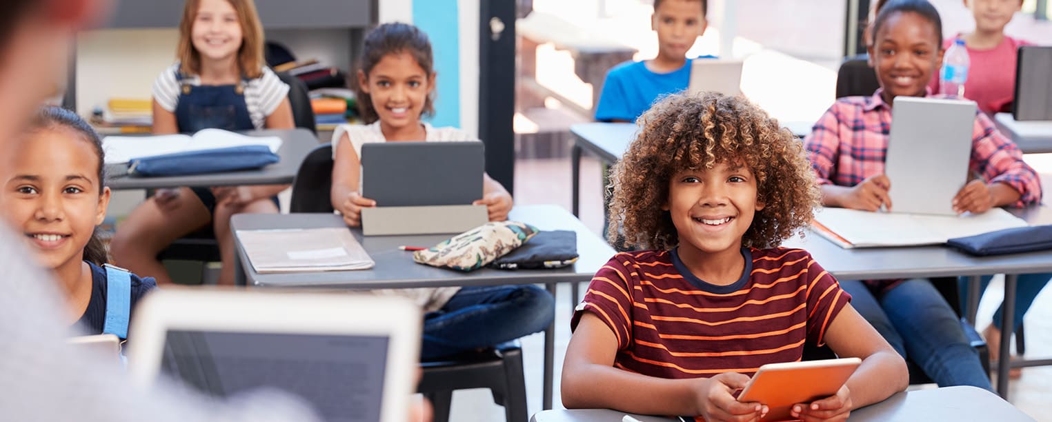 Children in classroom smiling